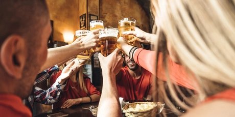 Group of happy friends drinking beer at the brewery
