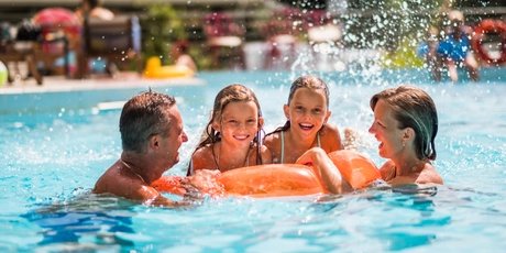 Happy family enjoying in the pool