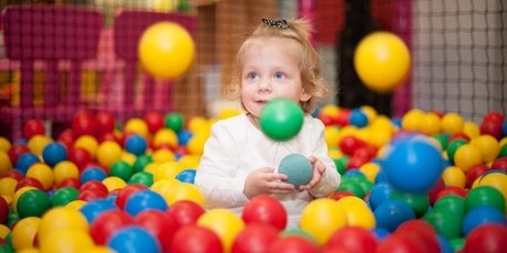Baby girl in ball pool