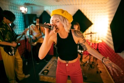 Young musicians having rehearsal at the music recording studio