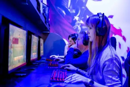 EGX Berlin: People with headphones on desktop computers