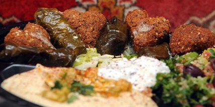 Oriental dishes stuffed vine leaves, hummus, heart-shaped falafel 