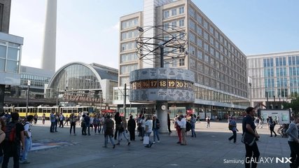 Menschen vor der Weltzeituhr am Alexanderplatz in Berlin